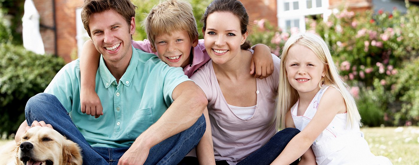 Smiling family of four outdoors