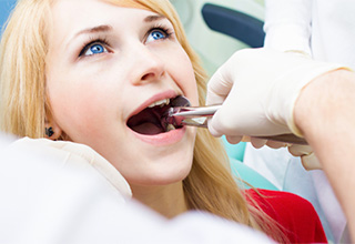 Patient having tooth extracted