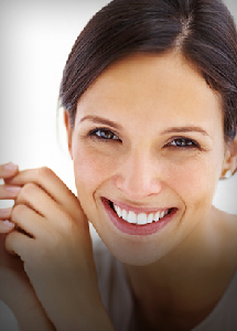 Smiling woman with brown hair in a ponytail
