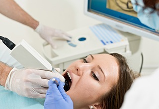 Denta patient having their mouth scanned with an intraoral camera