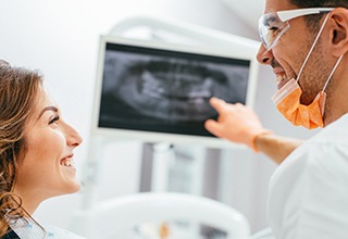 Dentist showing a patient x rays of their teeth