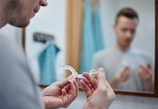 Patient preparing whitening trays at home