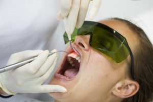 A woman receiving laser gum therapy.